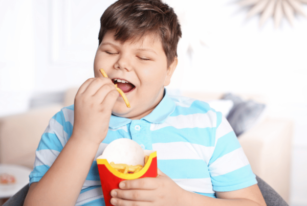 An obese child is having french fries