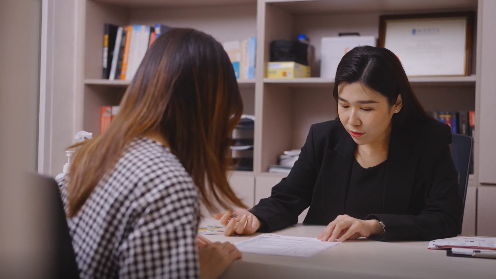 Doctor providing nutritional consultation to her client in her clinic