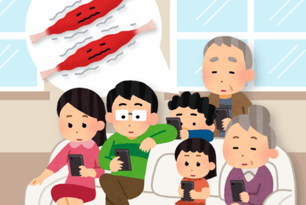A family sitting on a couch and playing on their phones in their living room