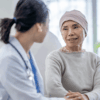 Female doctor reassuring her cancer patient in her hospital ward