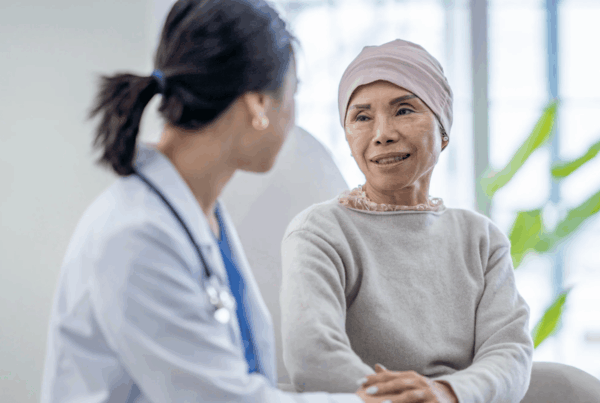 Female doctor reassuring her cancer patient in her hospital ward